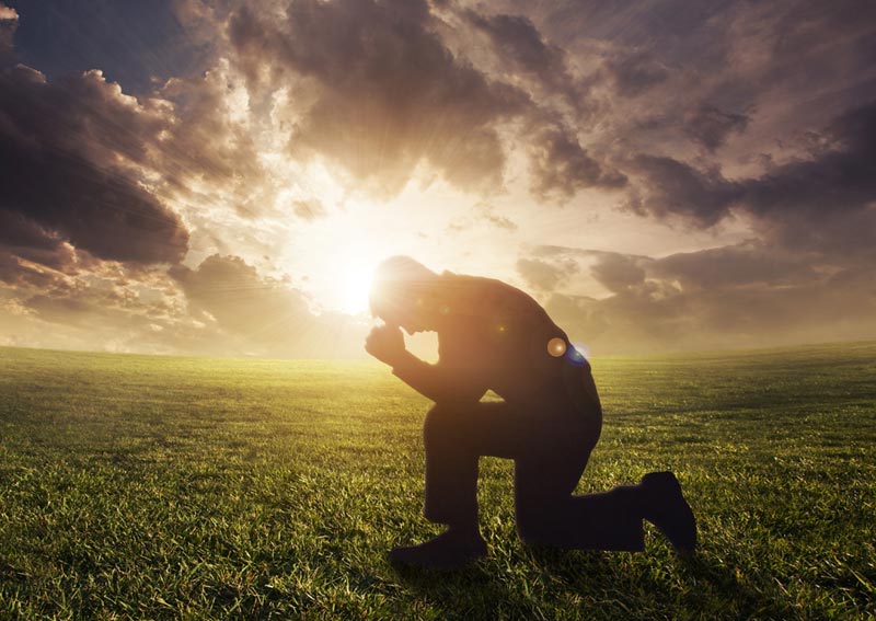 peoplemanprayinginfieldjpg